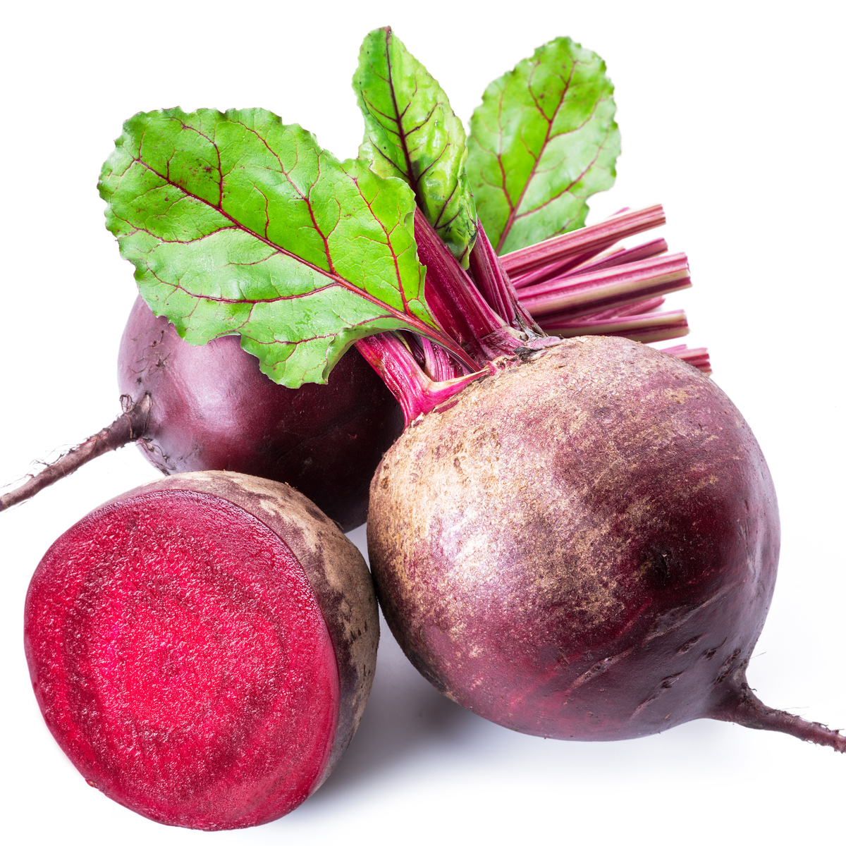 Fresh beetroot and leafy greens on a kitchen counter